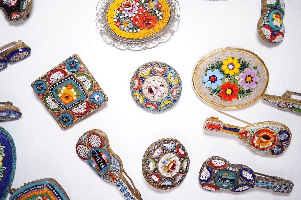 A collection of twenty-eight micro-mosaic brooches, including ten banjo and guitars shaped brooches, six similar large oval brooches, nine small brooches and three long brooches. (28) Condition - good